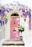 In this scene, a tranquil South Hornchurch doorway becomes a quiet celebration of homecoming. At its heart stands a pastel pink front door, painted in a soft, powdery blush that glows gently as daylight falls across its surface. Subtle panel details catch the light, adding depth and giving the sense of a lovingly maintained home, perhaps on a peaceful residential street near local schools and parks. Above the doorway, wisteria trails down in graceful cascades, each cluster of lavender and soft purple blooms forming a loose floral canopy. The blossoms hang like delicate tassels, framing the entrance and suggesting their sweet, heady fragrance drifting on a mild afternoon breeze. Surrounding walls are whitewashed and slightly textured, creating a soft backdrop that makes the pastel colours and gentle shadows stand out. A matching shutter in a similar pink tone completes the composition, reinforcing the harmonious, pastel palette. Resting neatly on the threshold is a smart grey bucket, filled generously with white and cream roses. The roses are lush and open, their velvety petals forming layered, rounded blooms that appear almost cloud-like against the muted metal of the bucket. Interspersed sprigs of green foliage provide contrast, their fresh tones giving the arrangement a sense of movement and life. A pink satin ribbon, tied carefully around the base of the bucket, echoes the colour of the door and falls softly across the step. The overall impression is one of gentle joy and quiet optimism, the kind of floral moment that welcomes someone into a new South Hornchurch home with grace, tenderness, and the unspoken promise of many happy days to come.